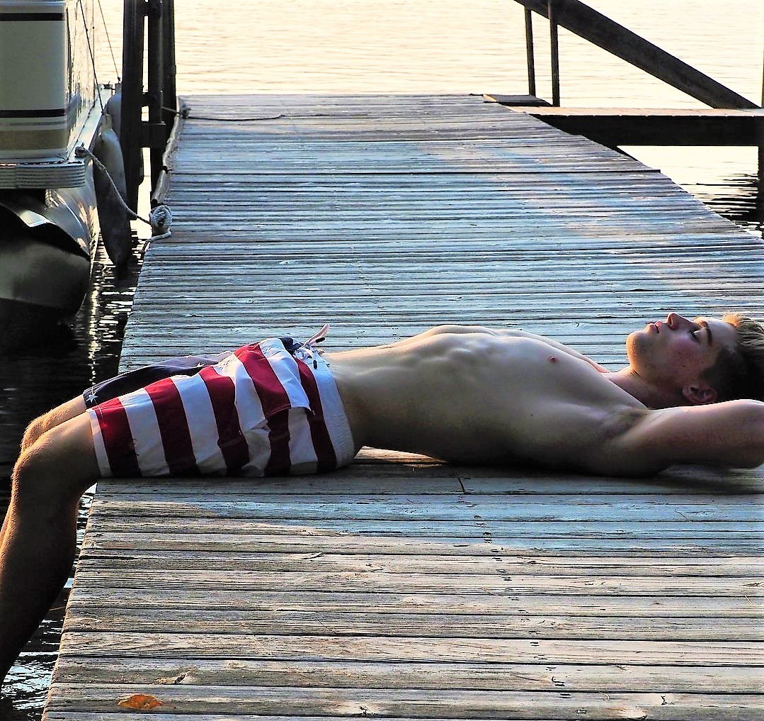 guy-in-shorts-laying-on-dock.jpeg