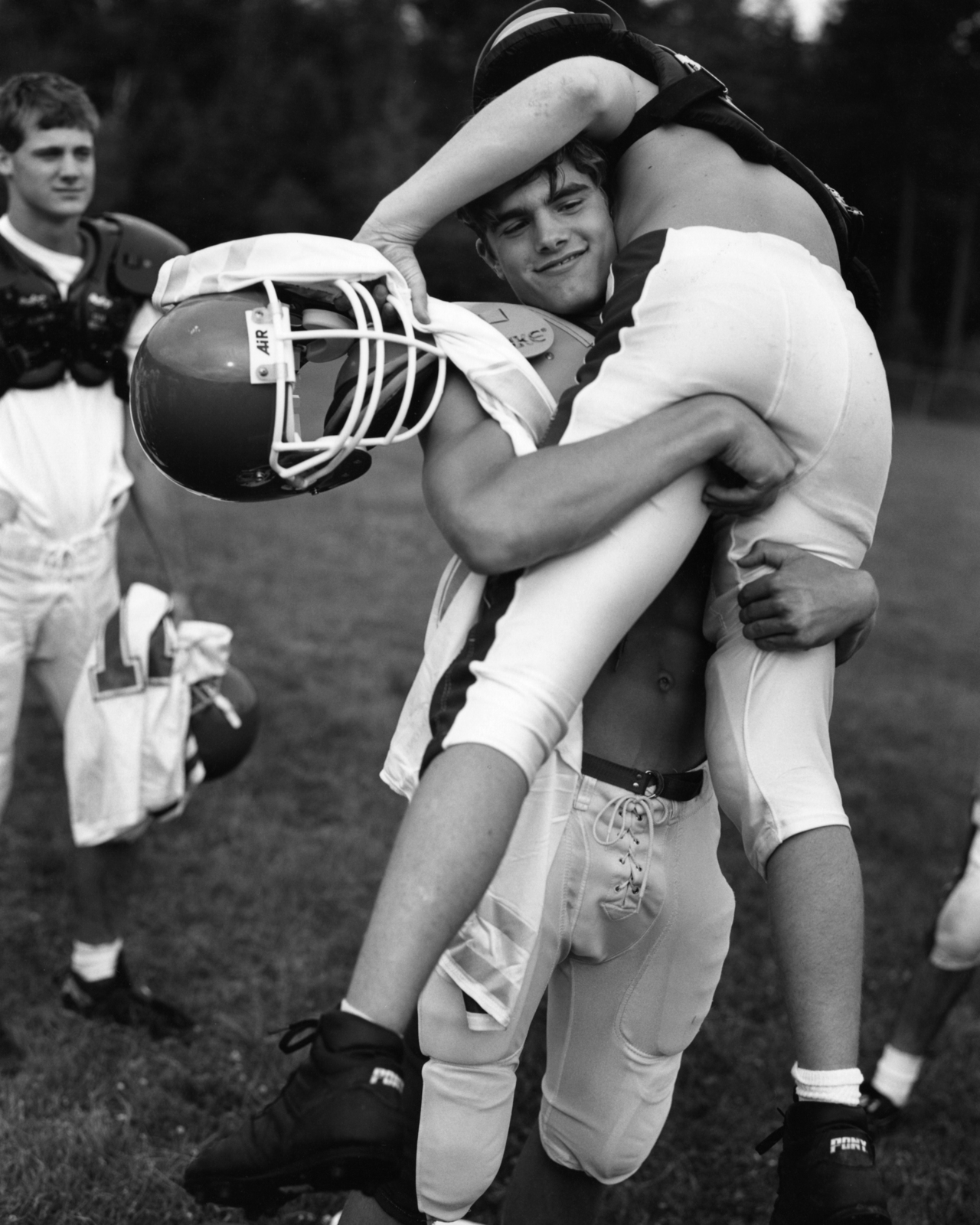 hot-college-football-guy-grabbing-teammate.jpeg