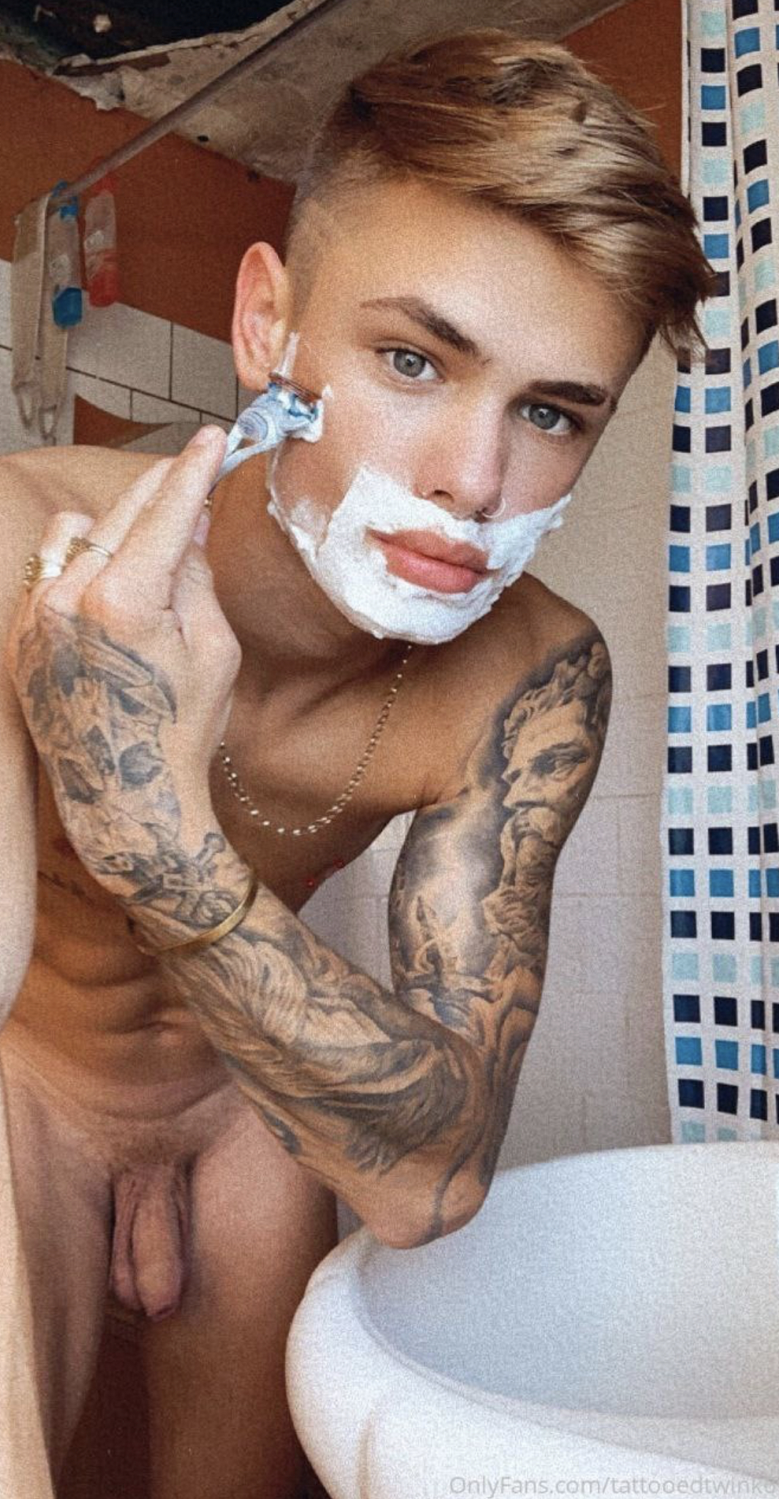 hot-young-guy-with-tattoos-shaving.jpeg