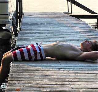 guy-in-shorts-laying-on-dock.jpeg