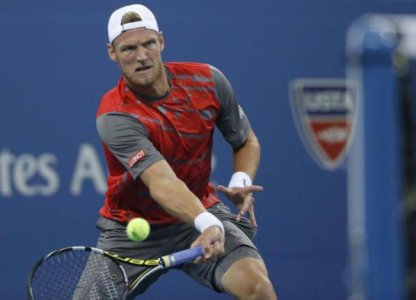 450971-sam-groth-of-australia-returns-a-shot-against-roger-federer-of-switzer.jpg
